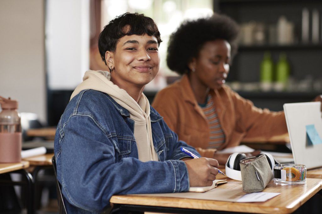 Teen girl sits at a desk while doing her homework
