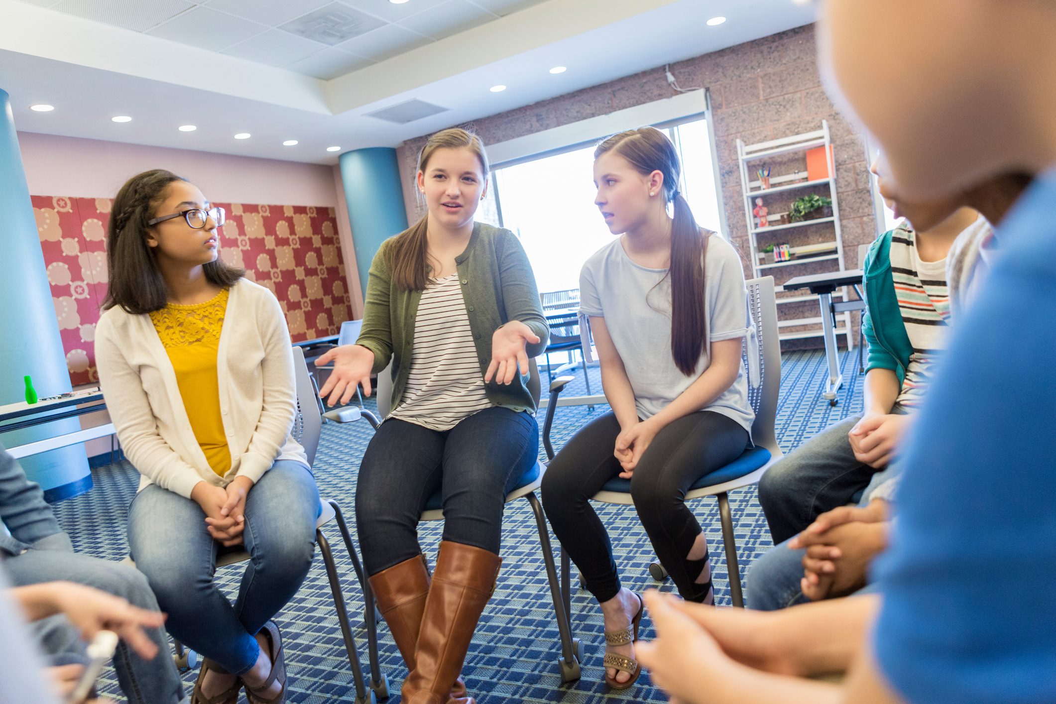 Teenage girl talks during support group meeting