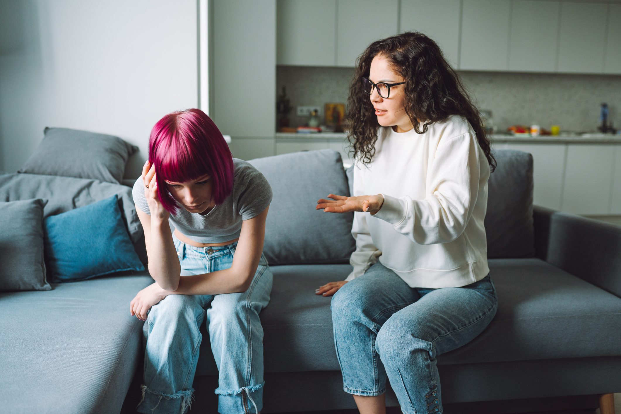 Mother scolding upset teenage daughter.